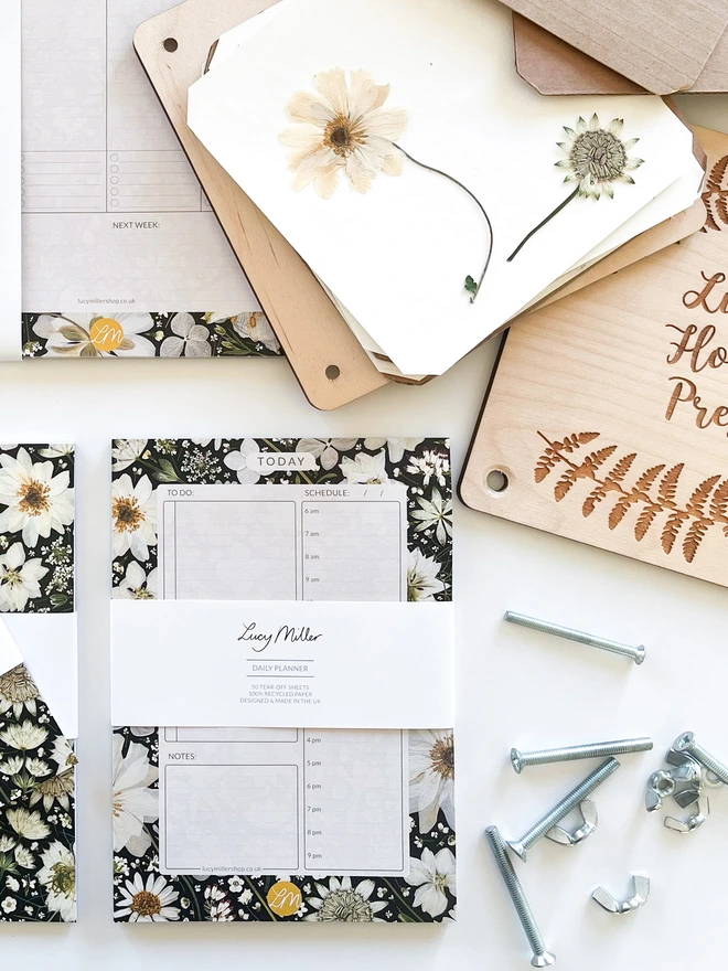 Daily planner desk pad with a black and white design created from pressed flowers. Great for busy individuals, families, and anyone balancing work and personal tasks.