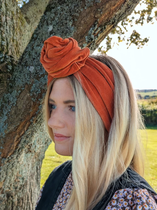 Orange headband on blonde haired woman