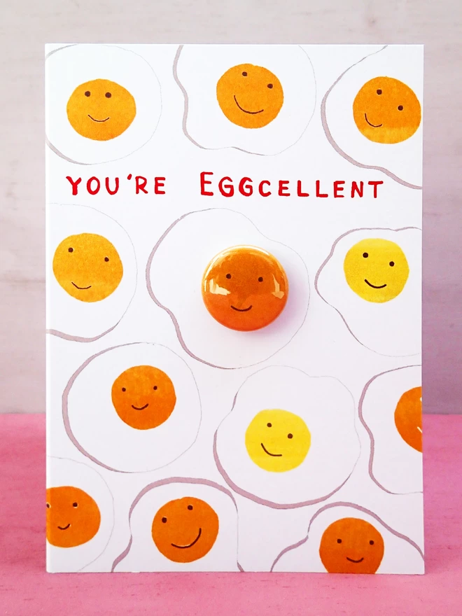 Eggcellent eggs greeting card with happy face pin badge