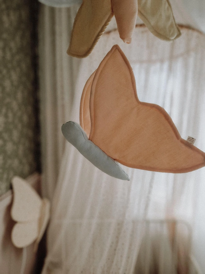 Butterfly Nursery Decoration, a colourful butterfly hanging decoration suspended in a kid's bedroom. 