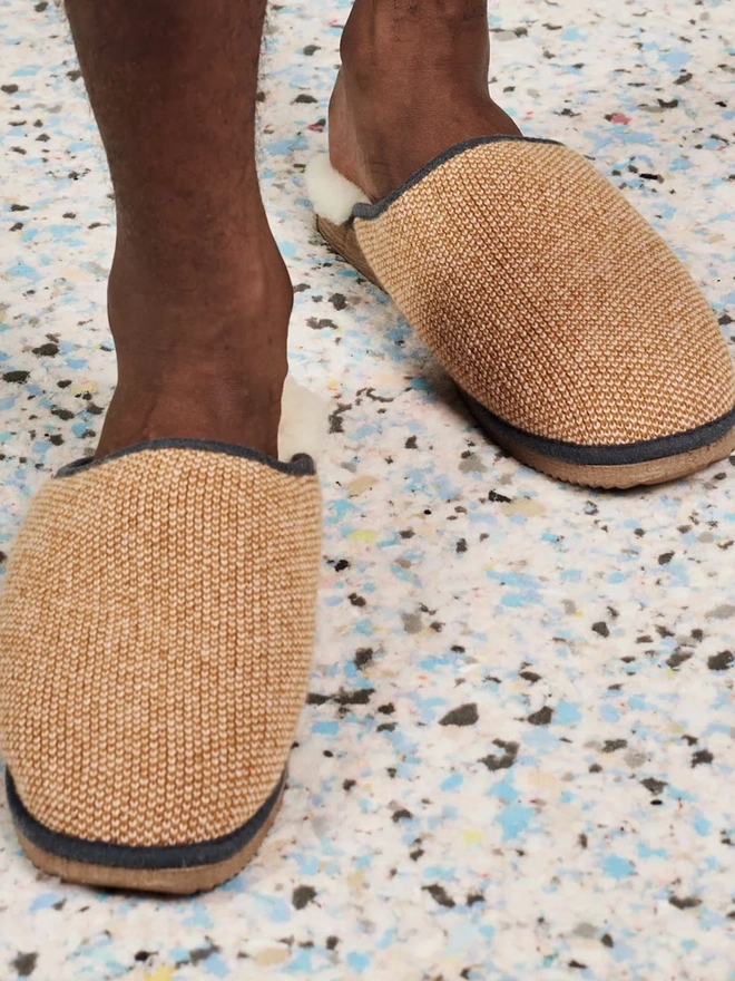 Women's Lambswool & Sheepskin Slippers, a person wearing a pair of colourful slippers indoors. 