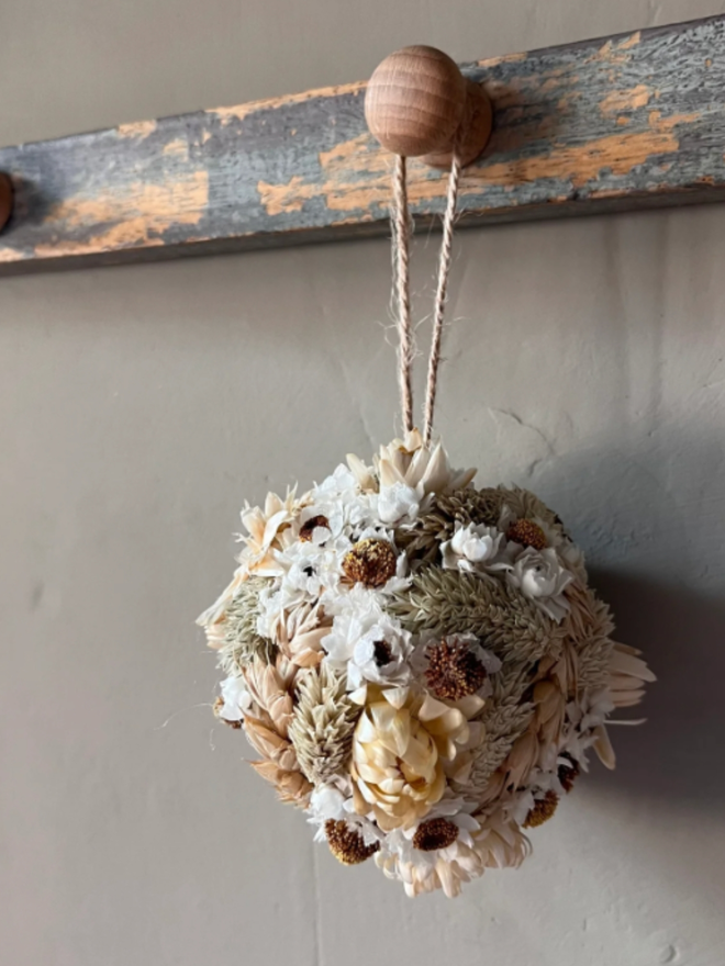 Snow Dried Flower Bauble. A dried flower bauble made of seasonal white flowers.