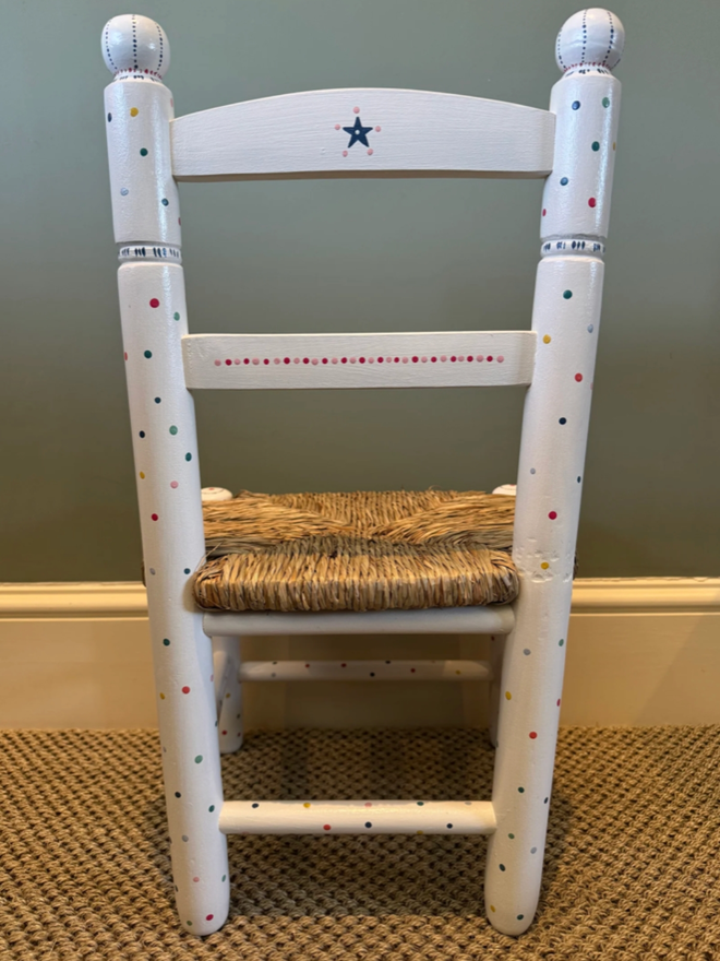 Ottilie Hand Painted Chair. A white chair with multicoloured dots.