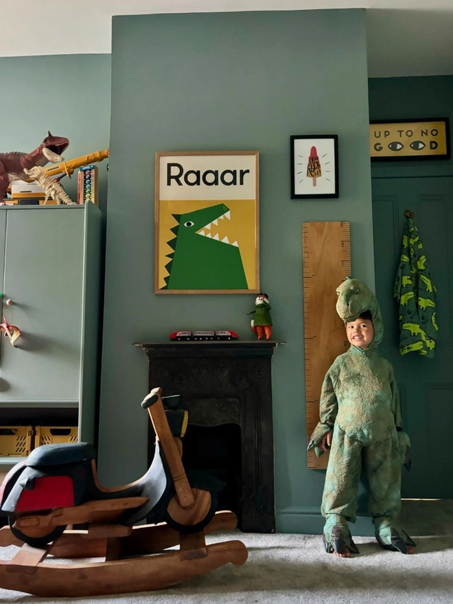 illustrated dinosaur print with the word Raar hanging on a child's bedroom wall