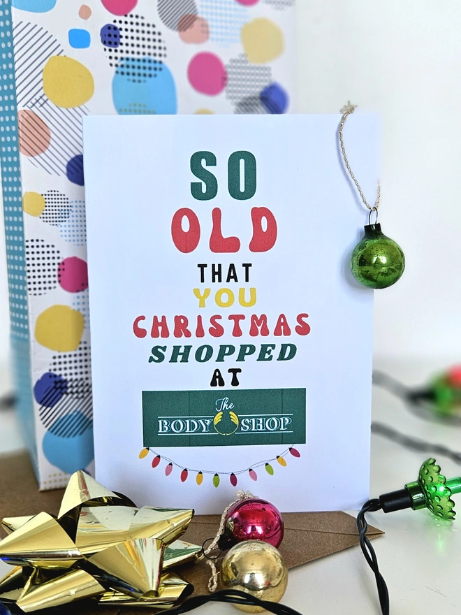 A photograph of the front of a humorous A6 greeting card illustrated using brightly coloured text and the retro shop logo. The text says so old you Christmas shopped at The Body Shop