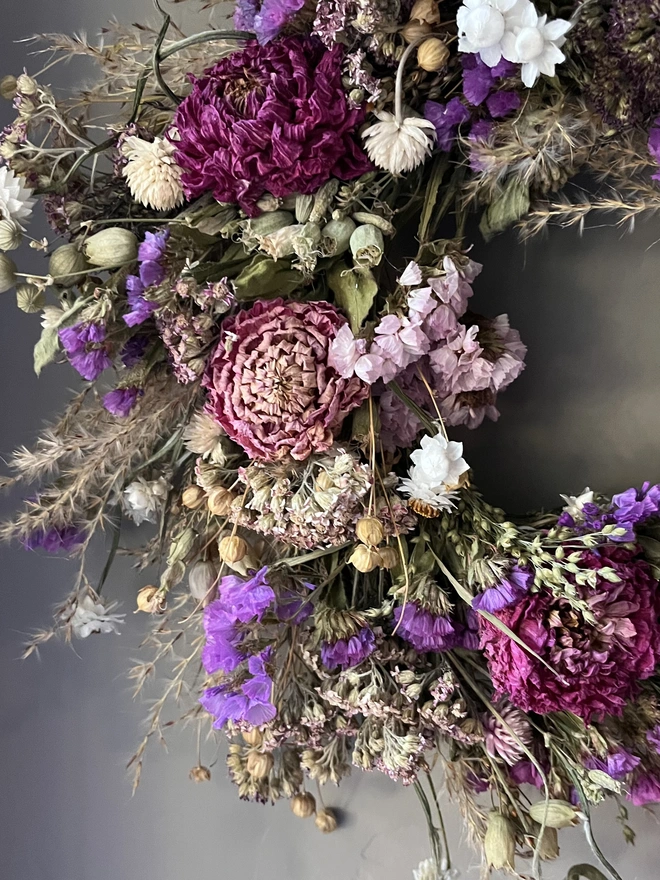 Pink and purple flower wreath made with a selection of seasonal blooms and dried dahlias. 