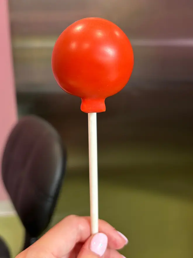 balloon cake pops (pack of 3). a red balloon cake pop on a stick.