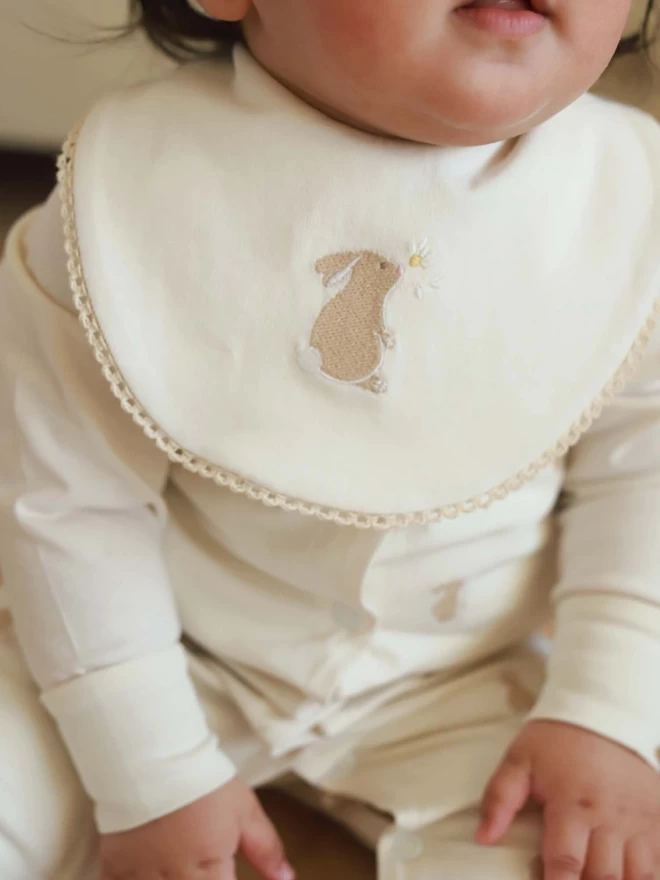 Embroidered Cotton Bib with a bunny worn by a baby