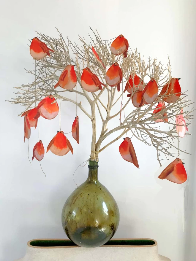paper garland of chubby robins strewn in a tree for festive decoration