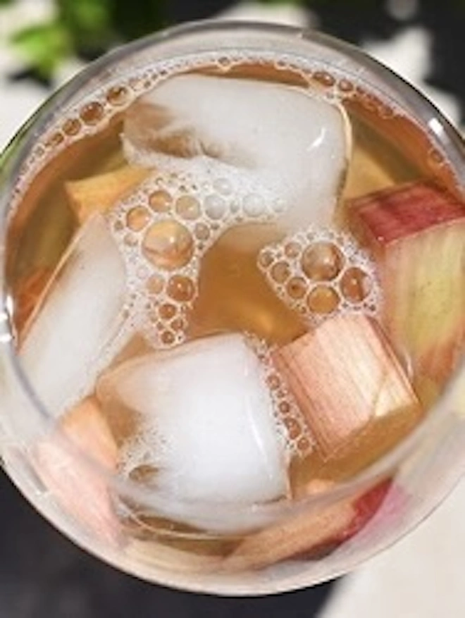 Elderflower & Rhubarb Cordial (Set Of 1, 2, 3 Or 4), a glass or cordial sitting on a wooden surface. 