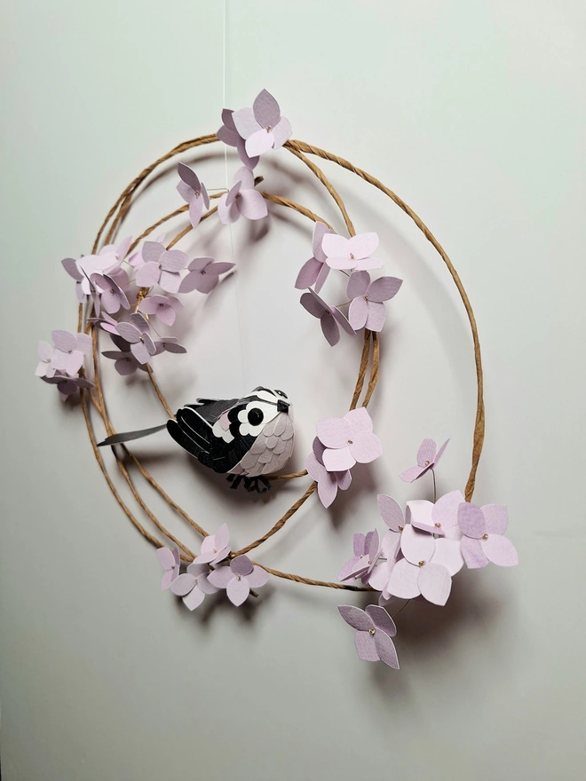long tailed tit on a lilac hydrangea wreath