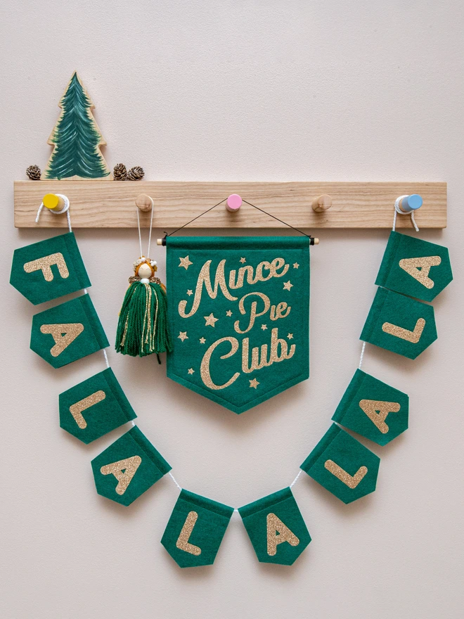 holly green FALALALALA christmas bunting on display with a mince pie club banner