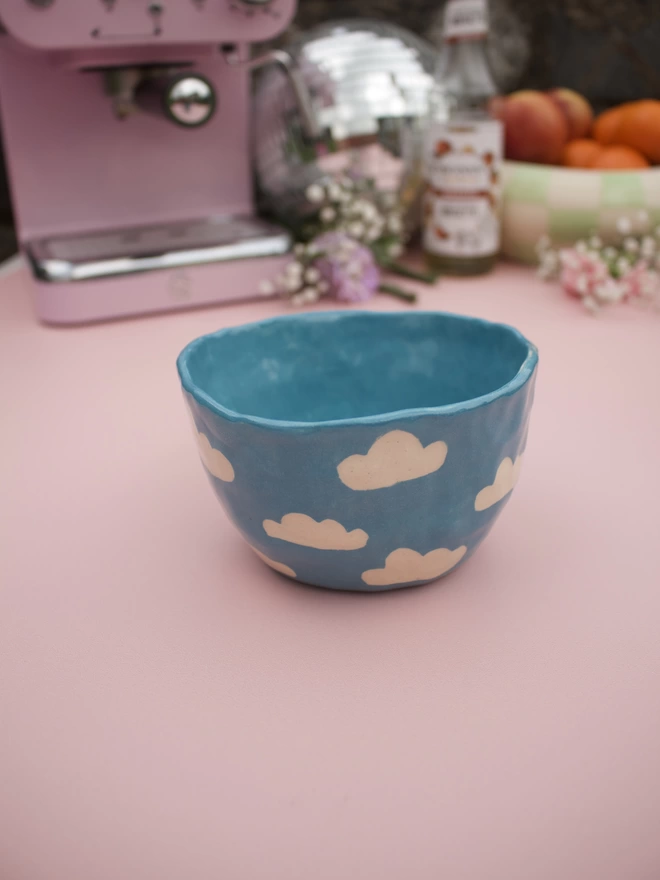 bright blue handmade stoneware pottery mug with white cloud pattern