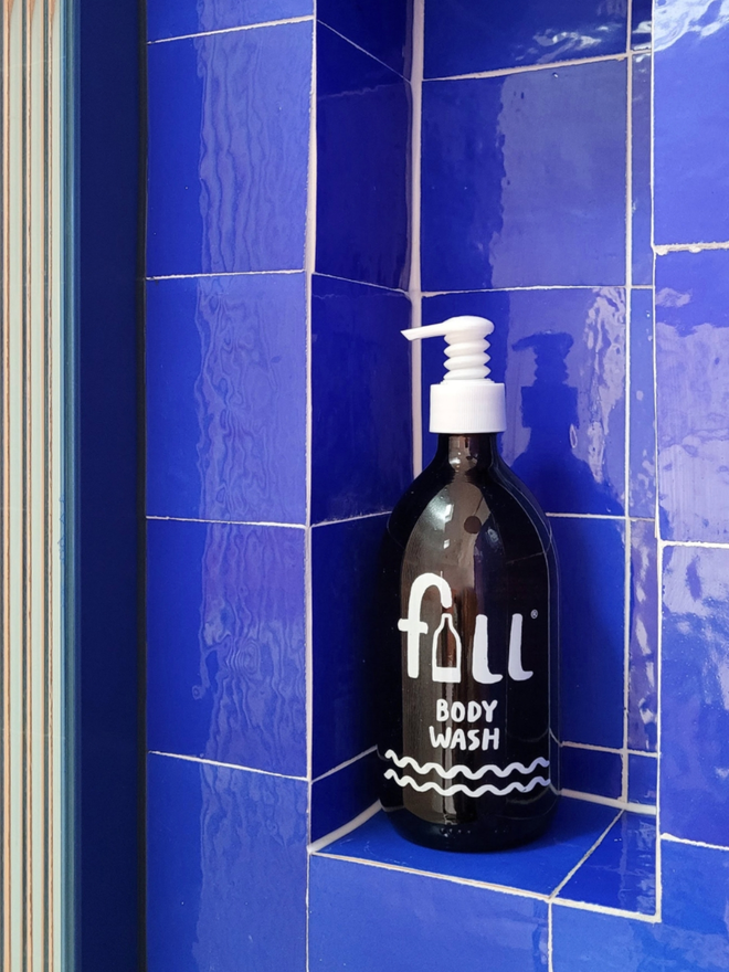 Body Wash. An amber bottle labelled Fill Body Wash against a blue background.