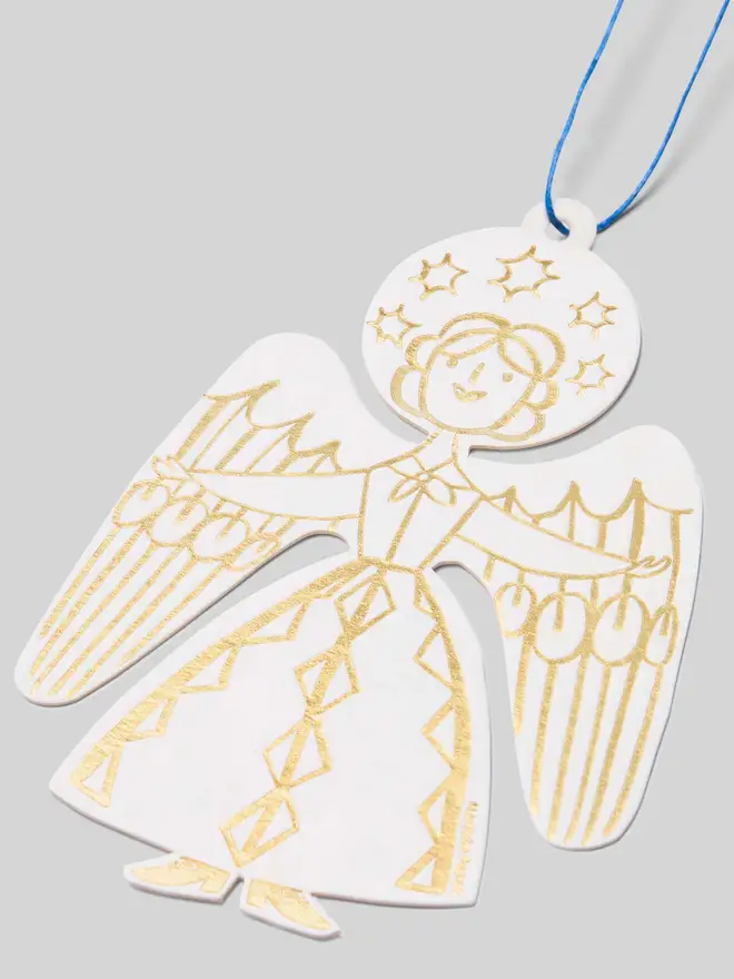 Gold angel Christmas tree decoration in white card with a blue string, on a gray background