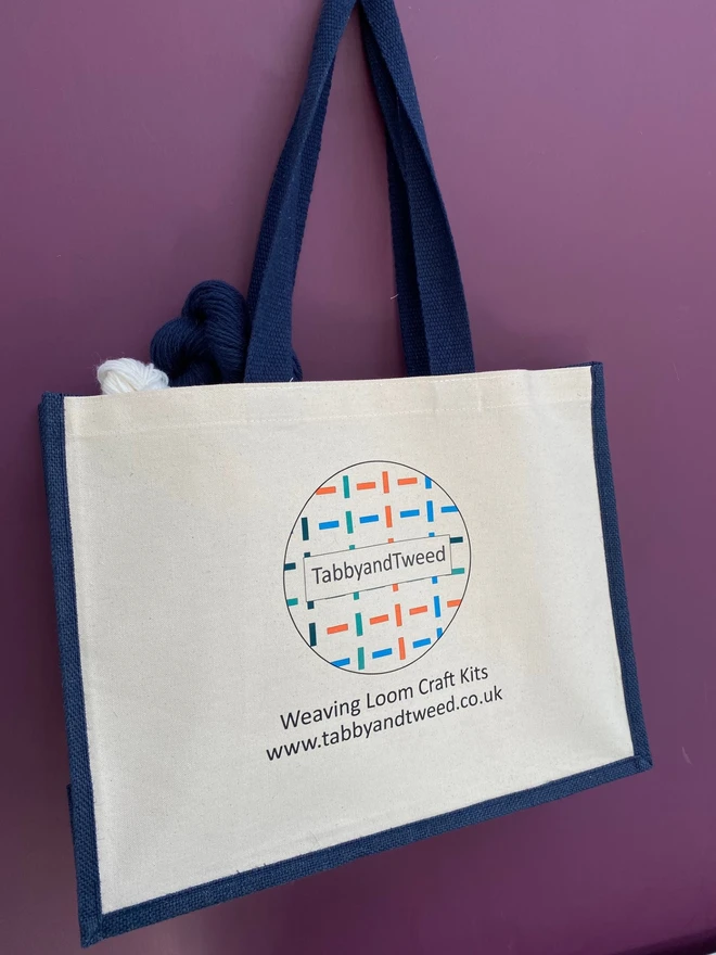 TabbyandTweed cream and navy project bag on a purple background