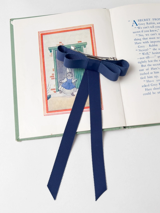 Blue girls hair bow on vintage book