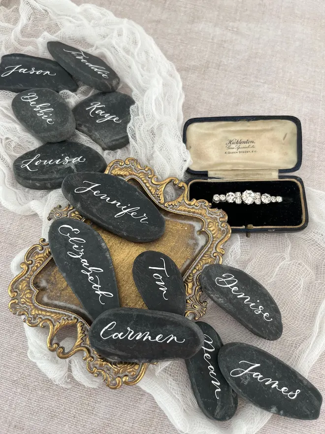 Wedding place cards written by hand on granite slices