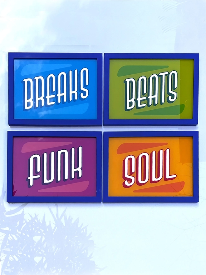 'Breaks, Beats,Funk, Soul' Gold Leaf Glass Artwork, against a white wall. 