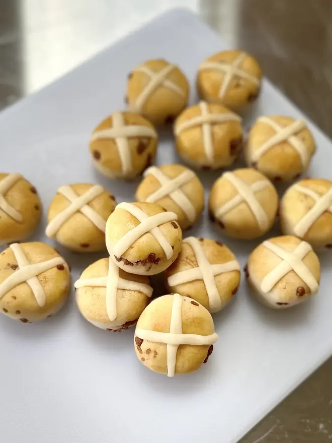 Marzipan Hot Cross Buns (Box Of 6 Or 9), a group of marzipan hot cross buns displayed glass surface. 