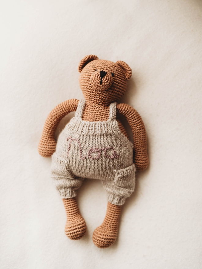 hand crochet brown teddy bear with personalised hand knit beige dungarees