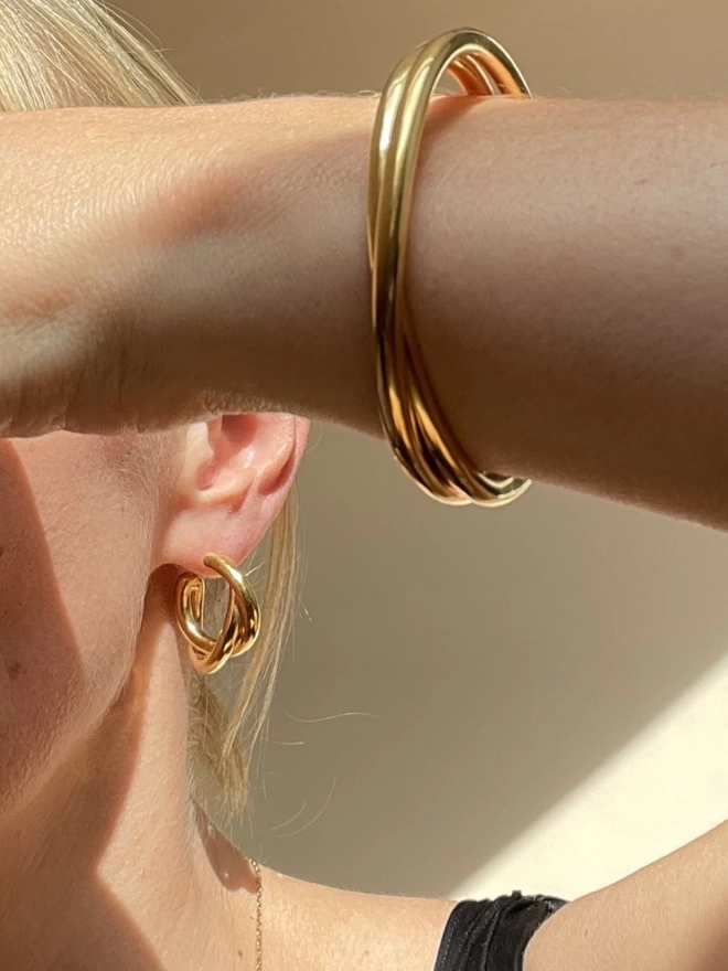 golden hoop and bangles with twisted, layered design