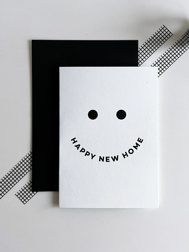 Minimal black and white Happy New Home greetings card with smiley design