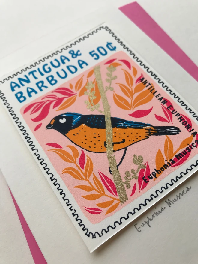 Bird Stamp Card Euphonia Musica Bird/Antigua & Barbuda, a white card with a colourful bird design on top of a purple envelope on a white background. 
