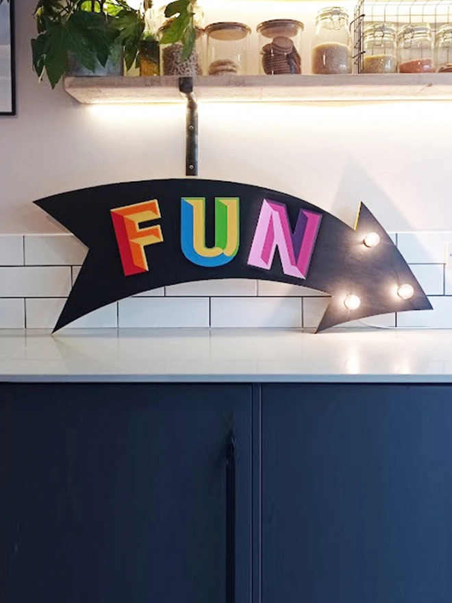 'Fun' circus arrow sign with lights