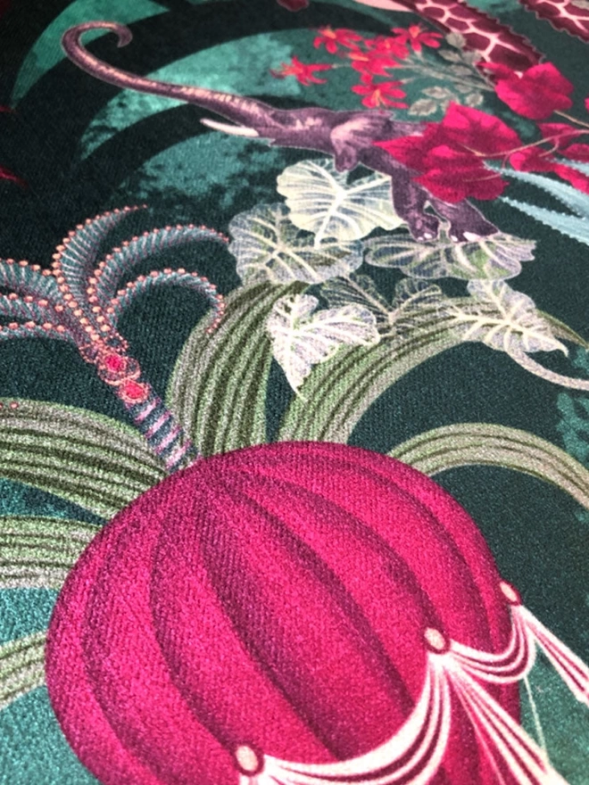 Close up of the green and pink velvet showing a pink air balloon and an elephant and pink flowers