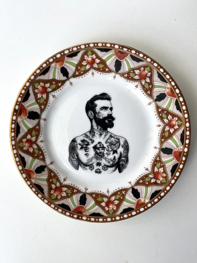 a vintage plate with ornate border, within the centre i have printed the vintage style image of a victorian tattooed sailor man