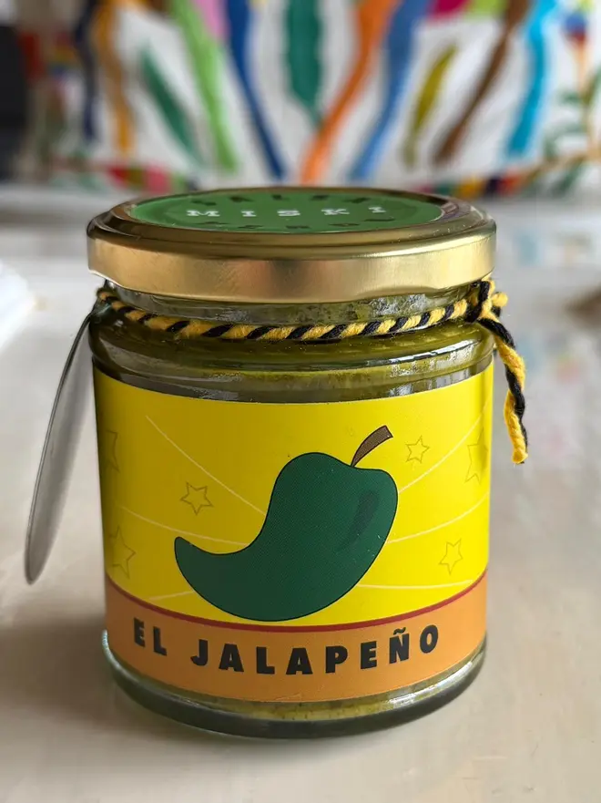'El Jalapeño' Salsa Jar (Set Of 1-4 Jars), a jar of salsa sitting on a kitchen counter top. It has an icon of a jalapeño on it. 