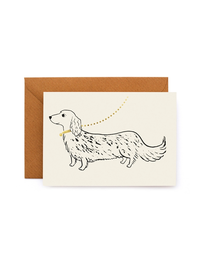 Greeting card with a picture of a dachsund sausage dog on a gold leash