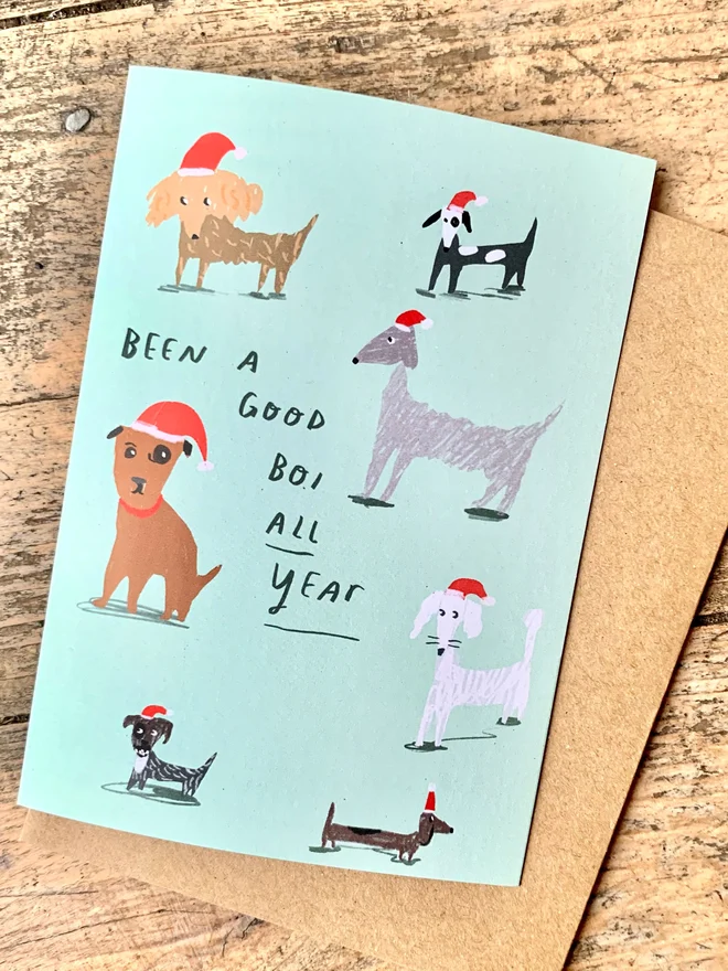 Card shows some dogs wearing santa hats and reads 'been a good boi all year'
