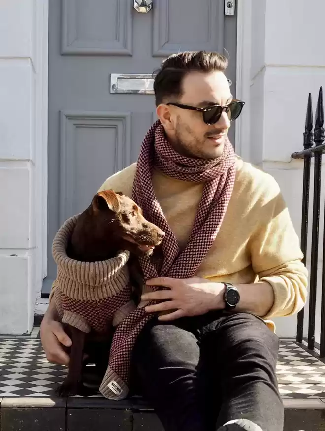man with a dog both in a matching set 