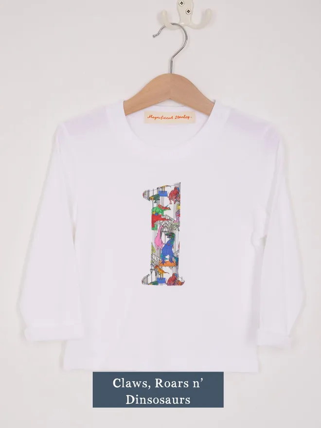 a white birthday t-shirt with a number 1 cut from liberty dinosaurs print on the front