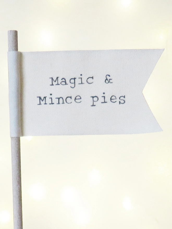 organic cotton flag with hand painted festive message wrapped round wooden dowel.