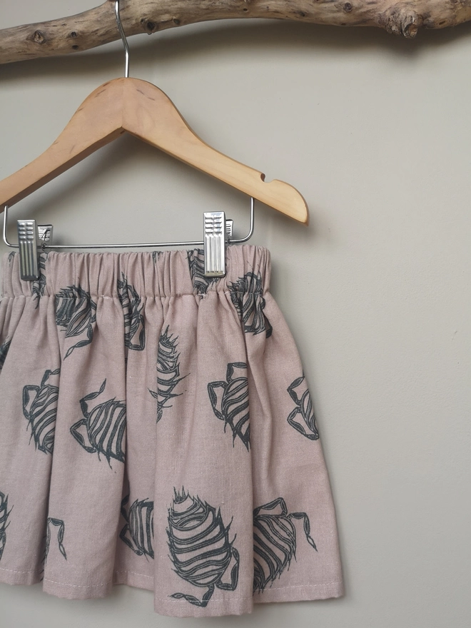 Girls Cotton Linen Pink Woodlouse Print Skirt. Elasticated Waist and Side Seam Pockets.