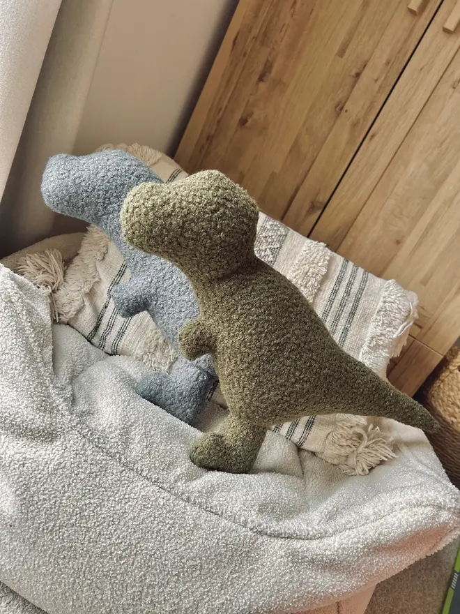 boucle dinosaur pillows. grey and green t-rex cushions.