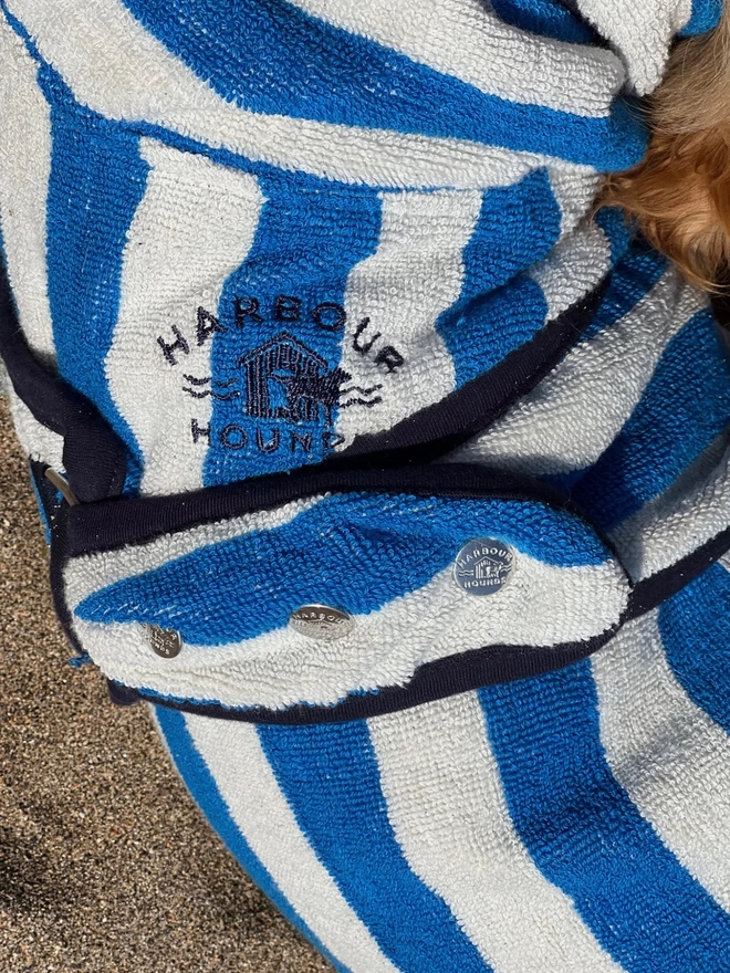 Nautically sea blue dog drying robe. 100% absorbent cotton. Popper fastening, tail hole and full belly coverage.  