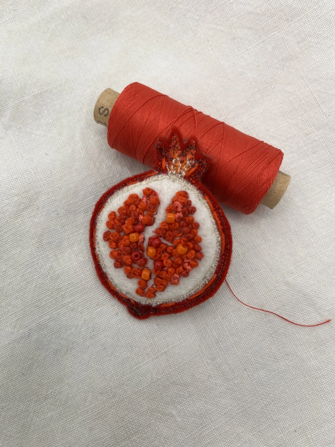 pomegranate and cotton reel