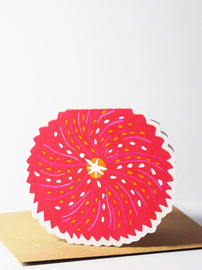 A cut out card of an urchin sitting on top of an envelope