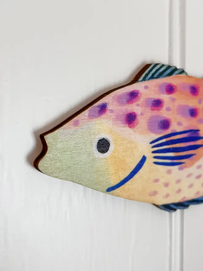 wooden fish wall decoration. close-up image of head of wooden fish wall decoration.