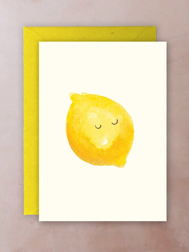 A greetings card with a watercolour lemon with its eyes closed/