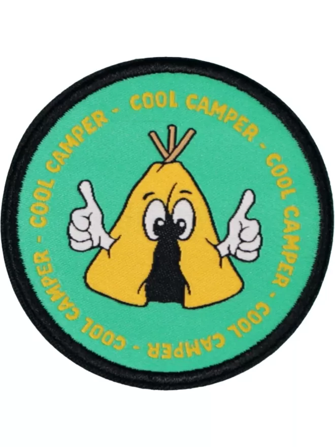 A circular patch with 'cool camper' repeated around the edge. In the centre is a tent holding its thumbs up.