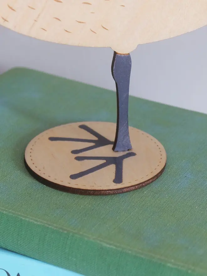Standing Wooden Curlew, wooden bird decoration standing on a platform on a book. 