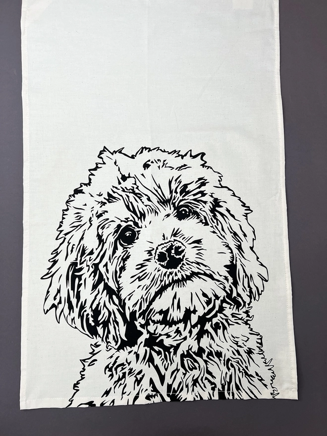 Full image of the cockapoo tea towel with the head and body of a cockapoo printed on the bottom half