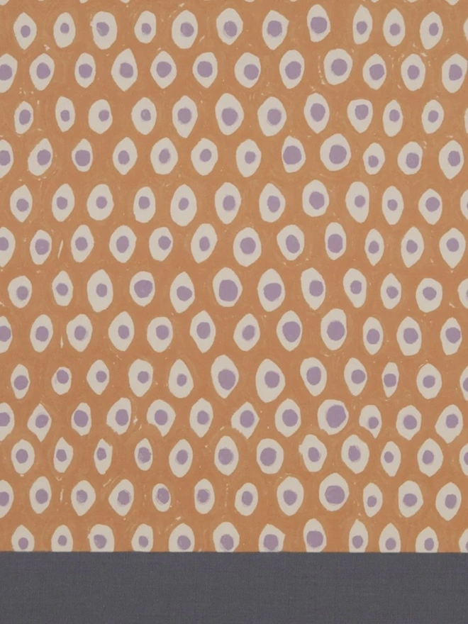 Retro Drum Lampshade. Close-up of a hand block printed lampshade showing a bold repeating geometric pattern. The colourful printed design and neat trim bring character and a handcrafted finish to any lamp.
