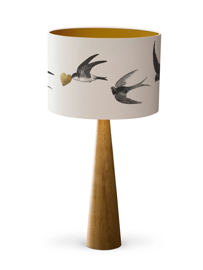 Handmade lampshade featuring graceful flying swallows swooping through a nature-inspired design, adding an elegant touch to any room.