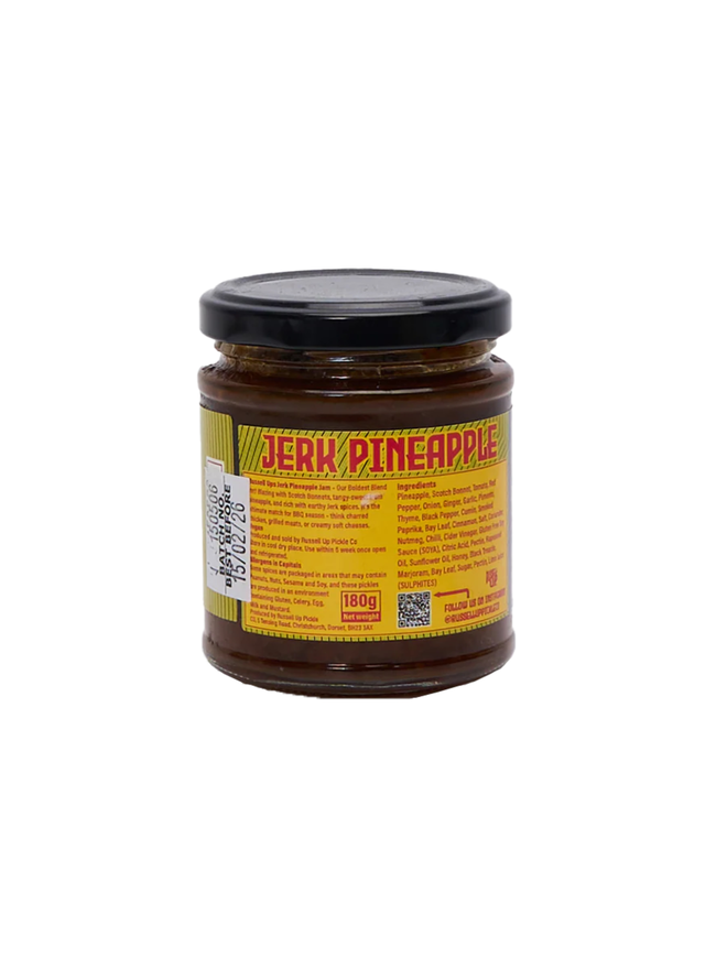 pineapple jerk relish. a jar of pineapple relish photographed against a white background, shown from the back to display the ingredients label.